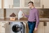 Man holding laundry detergent