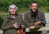 Older couple outdoors with cameras acting as senior photographers