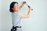 Asian woman with hammer