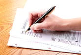 Person filling out IRS Form 1040EZ for federal income taxes