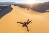 Man lying on sand dune