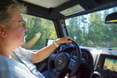 A woman drives a Jeep Wrangler