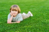 Child on green lawn