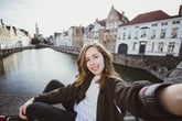 Woman on a boat in Belgium, taking a selfie.