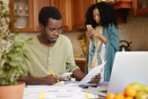 African American couple doing bills.