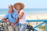 Couple with bike near seashore