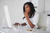 Woman eating lunch at her desk
