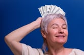 Smiling retired woman with money