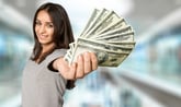 Smiling woman holding dollars