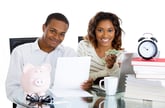 Couple doing bills, paying debt