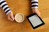 Woman reading a novel on a tablet