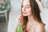 Woman drinking from reusable straw