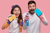 Couple with cleaning supplies
