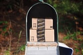 Amazon boxes sit in a mailbox