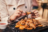 Woman eating chicken wings