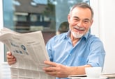 Happy retiree reading a newspaper