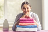 Happy woman with folded laundry