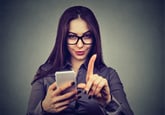 Young woman with smartphone showing no attention with finger hand gesture. Blocking forbidden adult contents, parental control reminder concept - Image