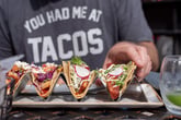 Man eating tacos at a restaurant