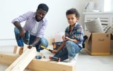 A father and his child work on a home improvement project