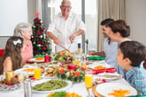 A family eats turkey for Christmas dinner