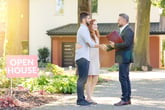 A young couple talks to a real estate agent