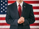 Political candidate in front of an American flag