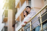 Couple on the balcony of their home