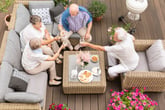 Senior friends eating outdoors on a deck