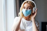 Woman in a mask and headphones