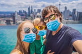 family posing for a coronavirus selfie in the city