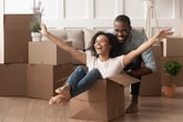 A millennial Black couple happily packs to move to another city