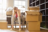Frustrated woman packing at home