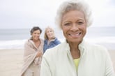 Senior woman on the beach with friends