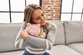 Woman hugging a piggy bank