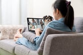 Woman in video meeting from home