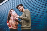 Young friends smiling at a smartphone video