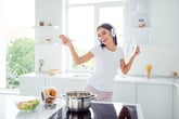 Woman singing while cooking