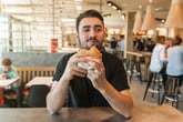 Man eating a burger at a restaurant