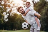 Father and son in the park with a soccer ball
