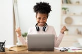Excited young woman at her laptop