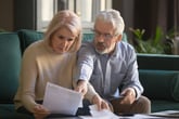 older couple reviewing finances confused