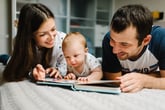 New parents and baby looking at photos