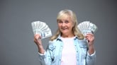 retiree senior woman holding money