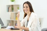 Smiling woman thumbs up taxes paperwork
