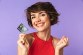 Smiling woman excited about her new credit card