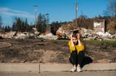 Woman outside her ruined home after a natural disaster or fire