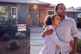 couple in front of home for sale by owner
