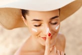 Woman with floppy hat and sunscreen