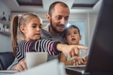 Dad with two kids looking at computer